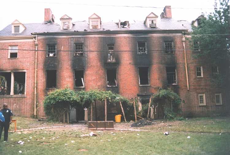 A building with burned windows AI-generated content may be incorrect.