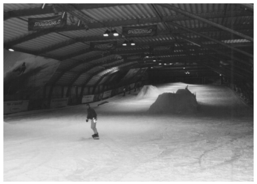 A person on a snowboard in a large indoor arena AI-generated content may be incorrect.